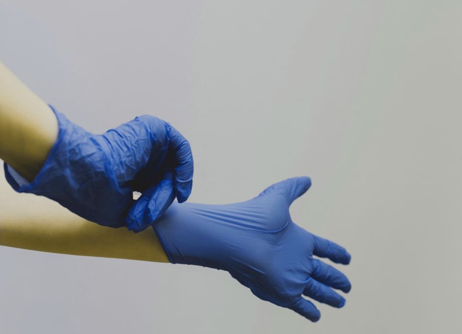 freelance medical writer putting on gloves during PhD lab work